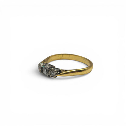18ct yellow gold diamond ring by Reeves and Sons, featuring sparkling diamonds and a sleek band design.