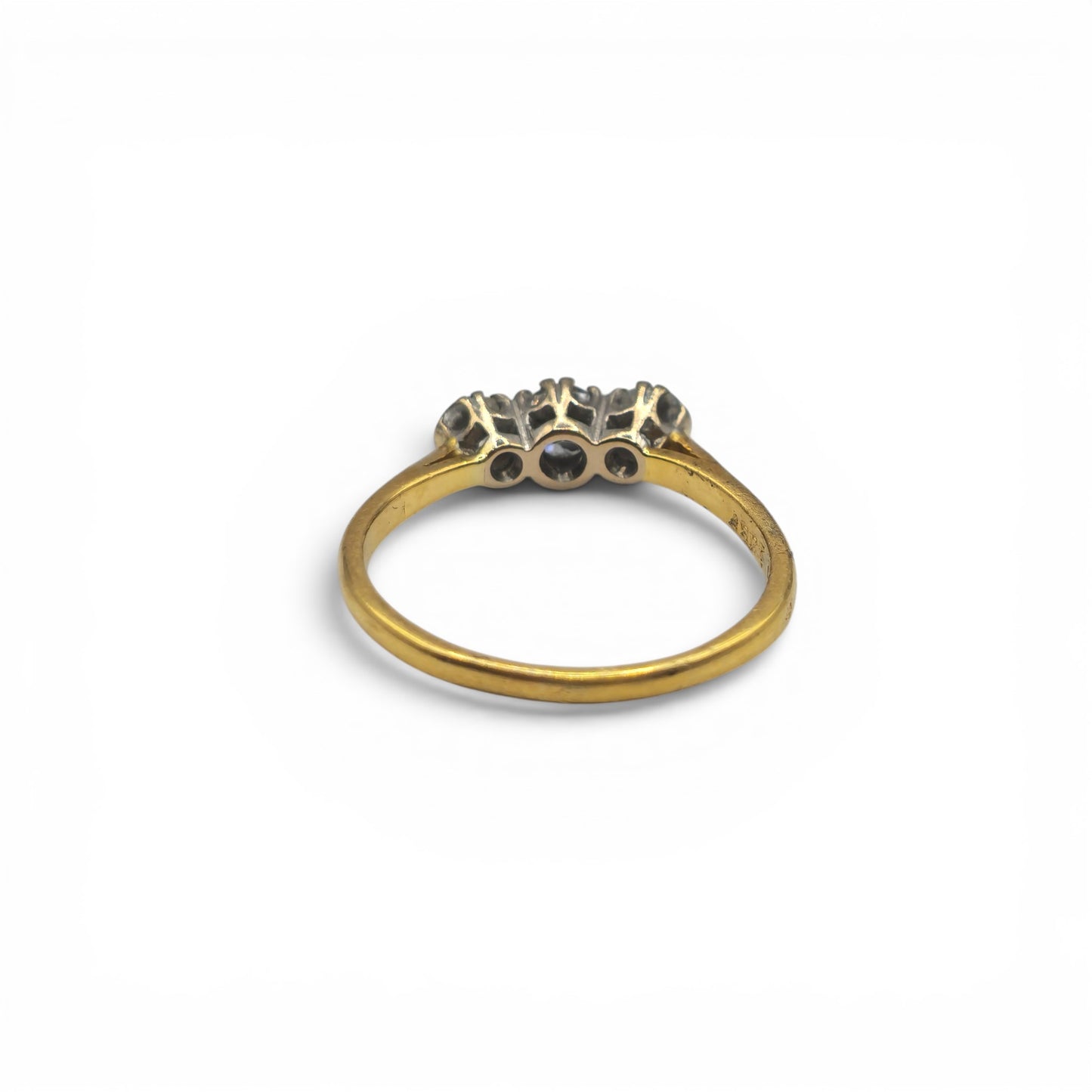 18ct yellow gold three-stone diamond ring by Reeves and Sons, showcasing sparkling diamonds and elegant design.