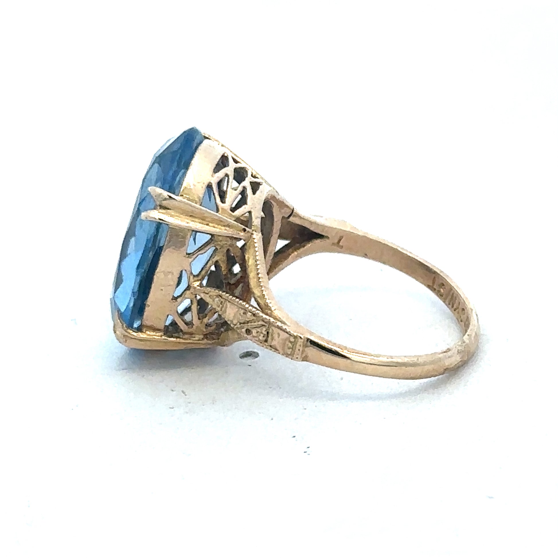 9ct yellow gold ring by Reeves and Sons, showcasing a sleek and polished design with a smooth band and subtle shine.