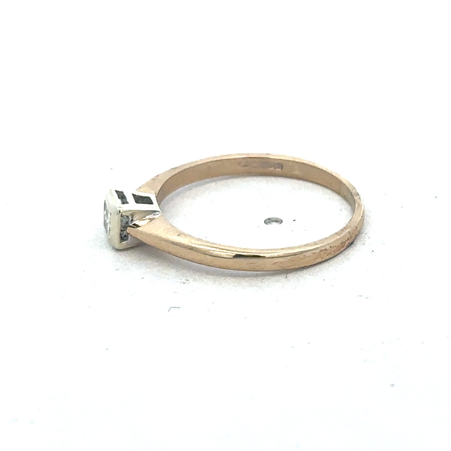 9ct yellow gold diamond ring by Reeves and Sons, showcasing a sparkling diamond set in a polished gold band.