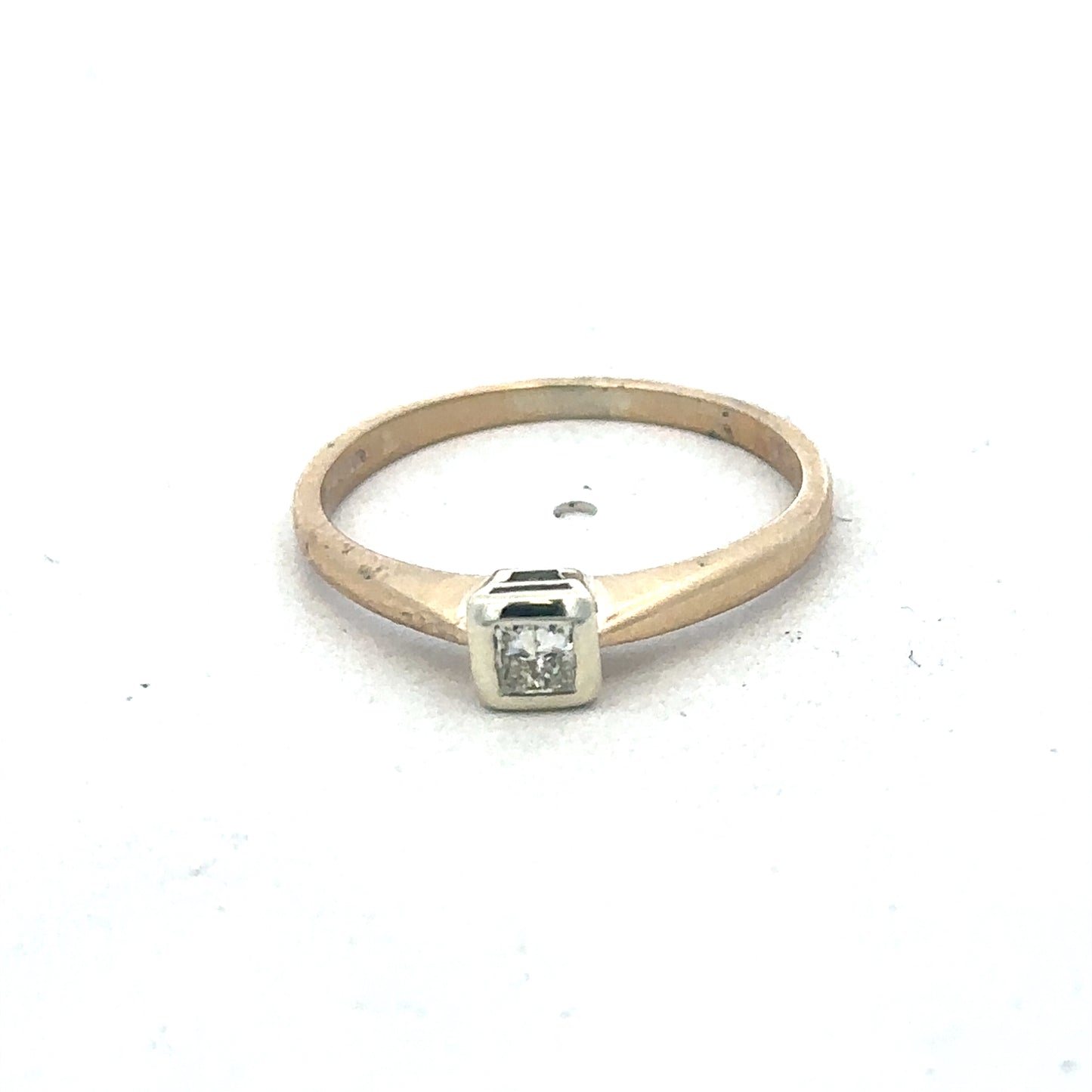 9ct yellow gold diamond ring by Reeves and Sons, featuring sparkling diamonds and elegant design, shown in close-up.