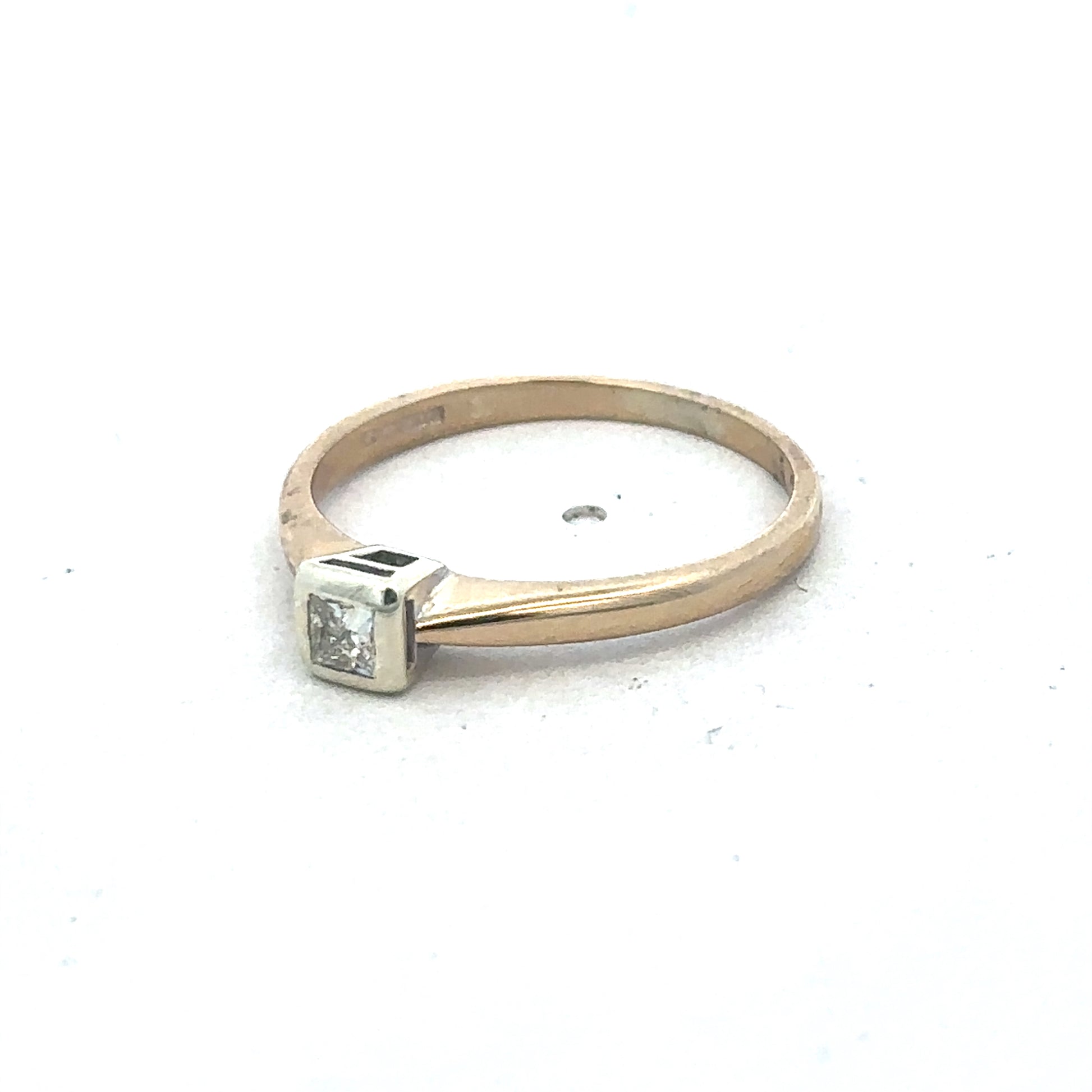 9ct yellow gold diamond ring by Reeves and Sons featuring a sparkling central diamond and elegant band design.