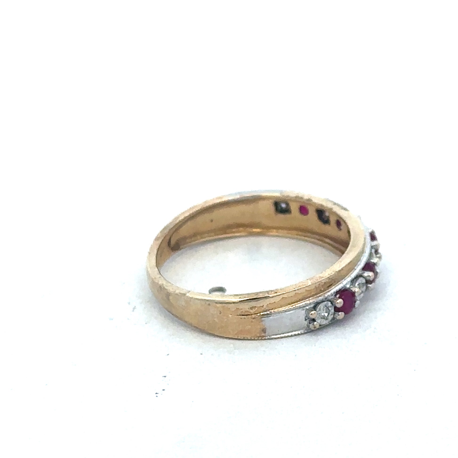 9ct yellow gold ruby and diamond ring by Reeves and Sons featuring a central ruby gemstone and sparkling diamond accents.