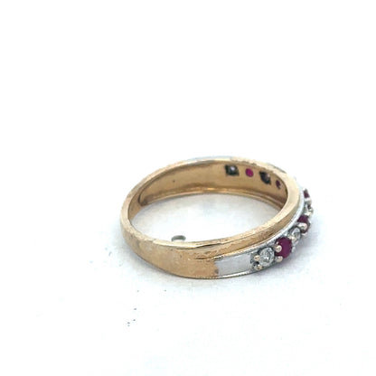 9ct yellow gold ruby and diamond ring by Reeves and Sons featuring a central ruby gemstone and sparkling diamond accents.