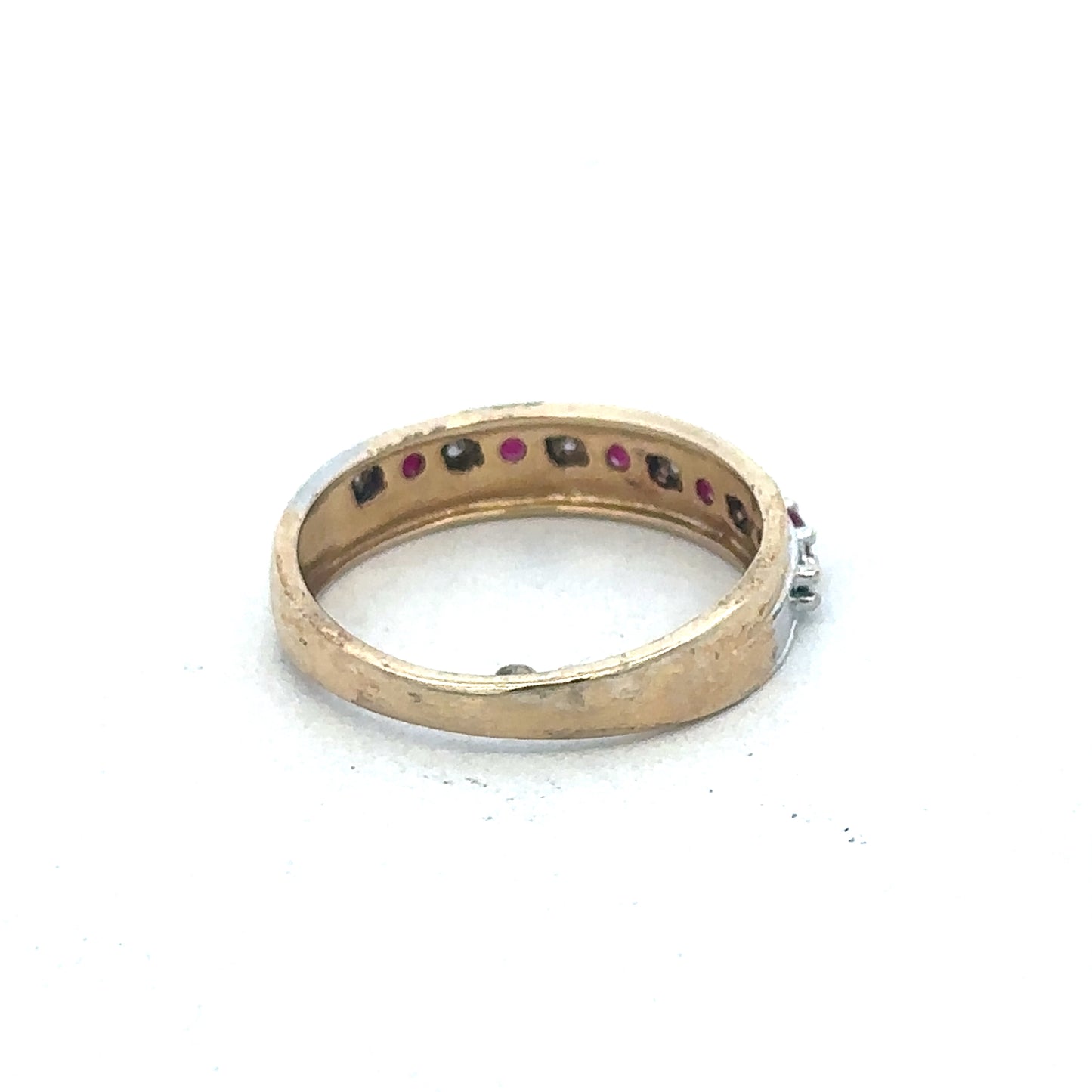 9ct yellow gold ruby and diamond ring by Reeves and Sons, featuring a central ruby surrounded by sparkling diamonds.