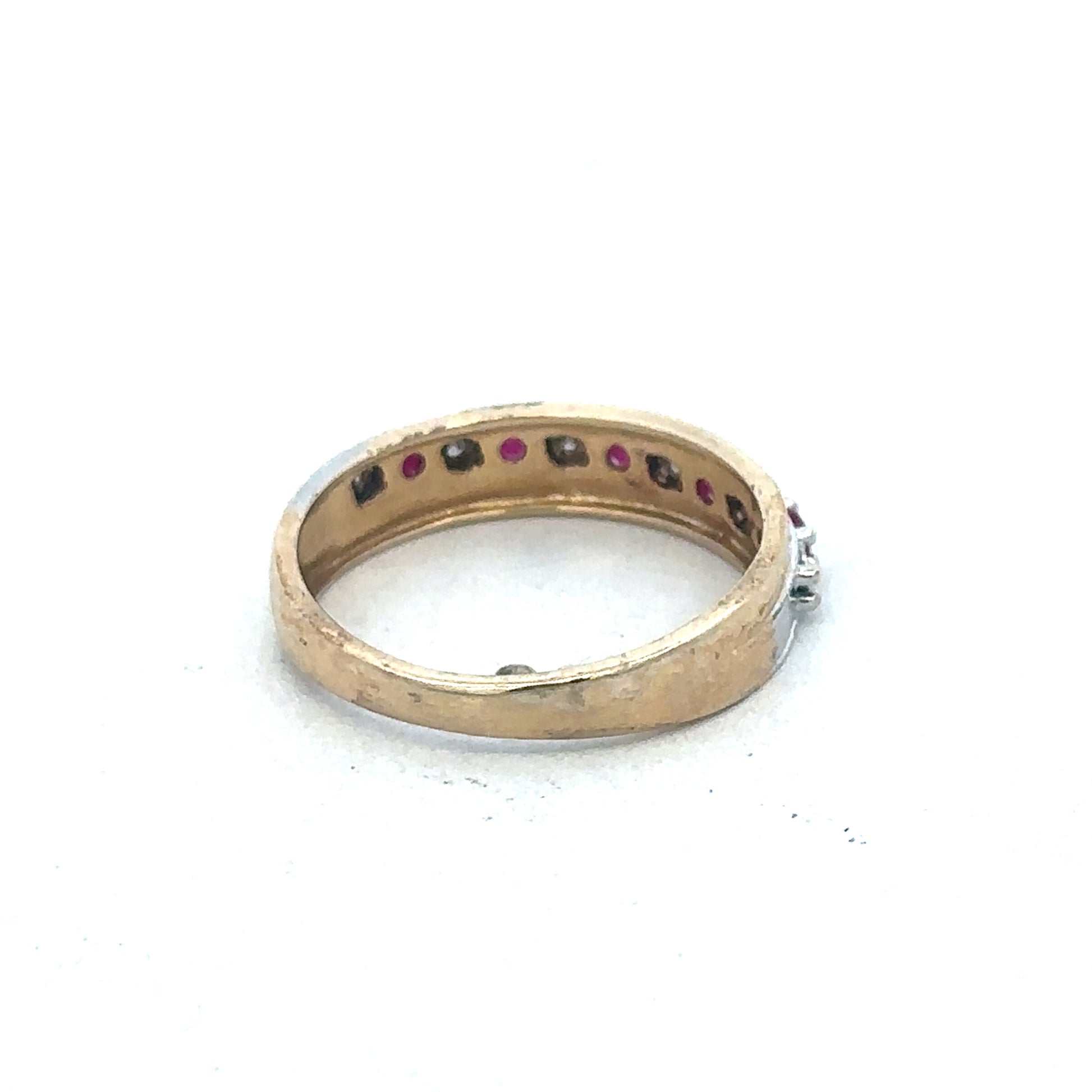9ct yellow gold ruby and diamond ring by Reeves and Sons, featuring a central ruby surrounded by sparkling diamonds.