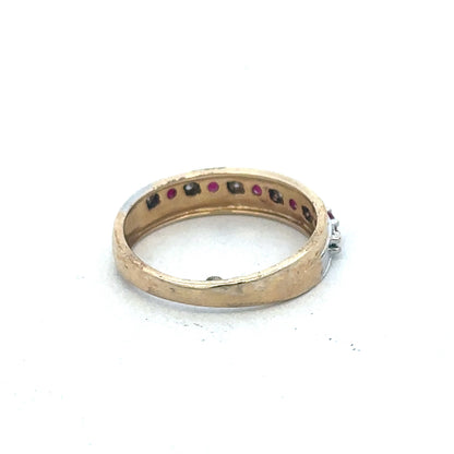 9ct yellow gold ruby and diamond ring by Reeves and Sons, featuring a central ruby surrounded by sparkling diamonds.