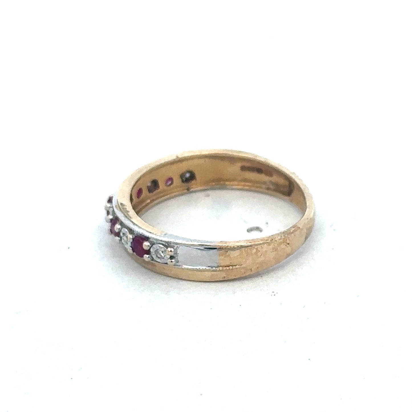 9ct yellow gold ruby and diamond ring by Reeves and Sons, featuring a central ruby surrounded by sparkling diamonds.