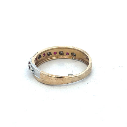 9ct yellow gold ruby and diamond ring by Reeves and Sons, showcasing a central ruby with diamond accents on a polished band