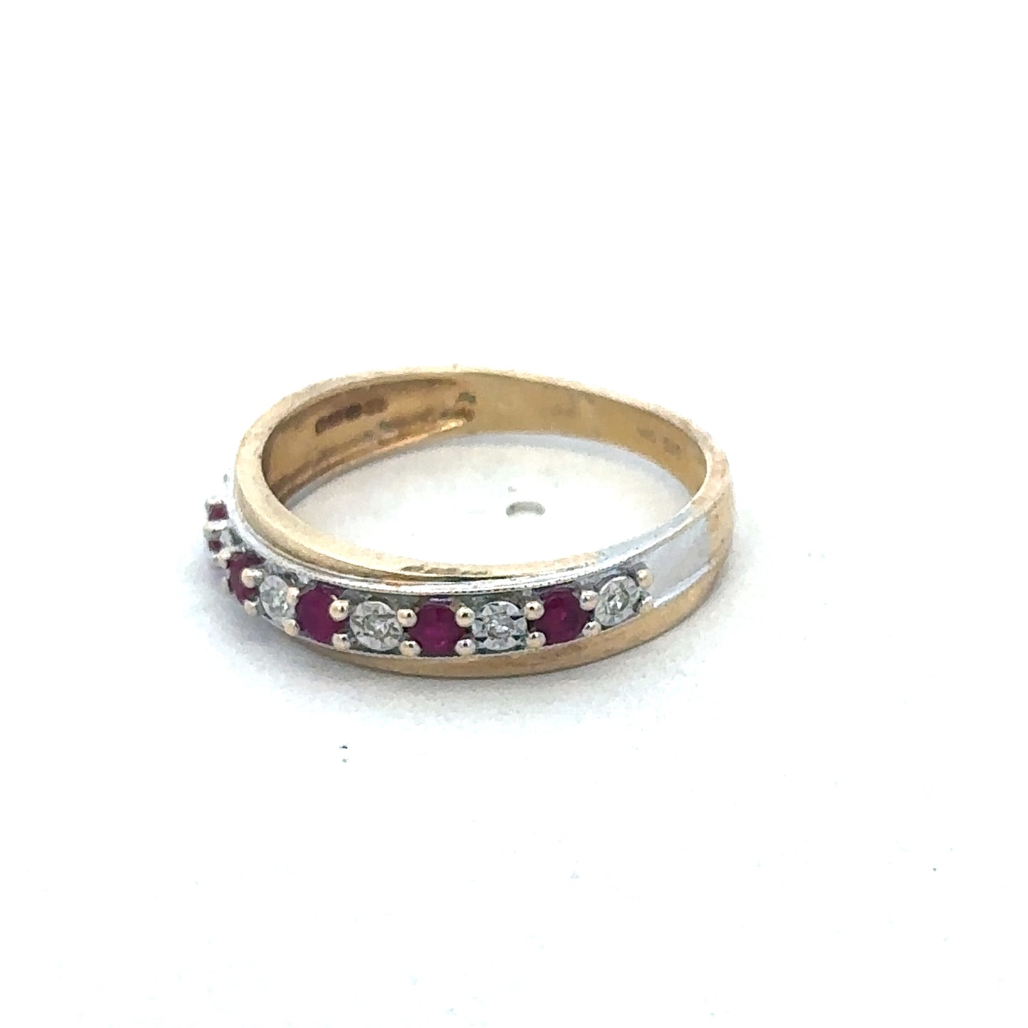 9ct yellow gold ruby and diamond ring by Reeves and Sons, featuring a central ruby surrounded by sparkling diamonds.