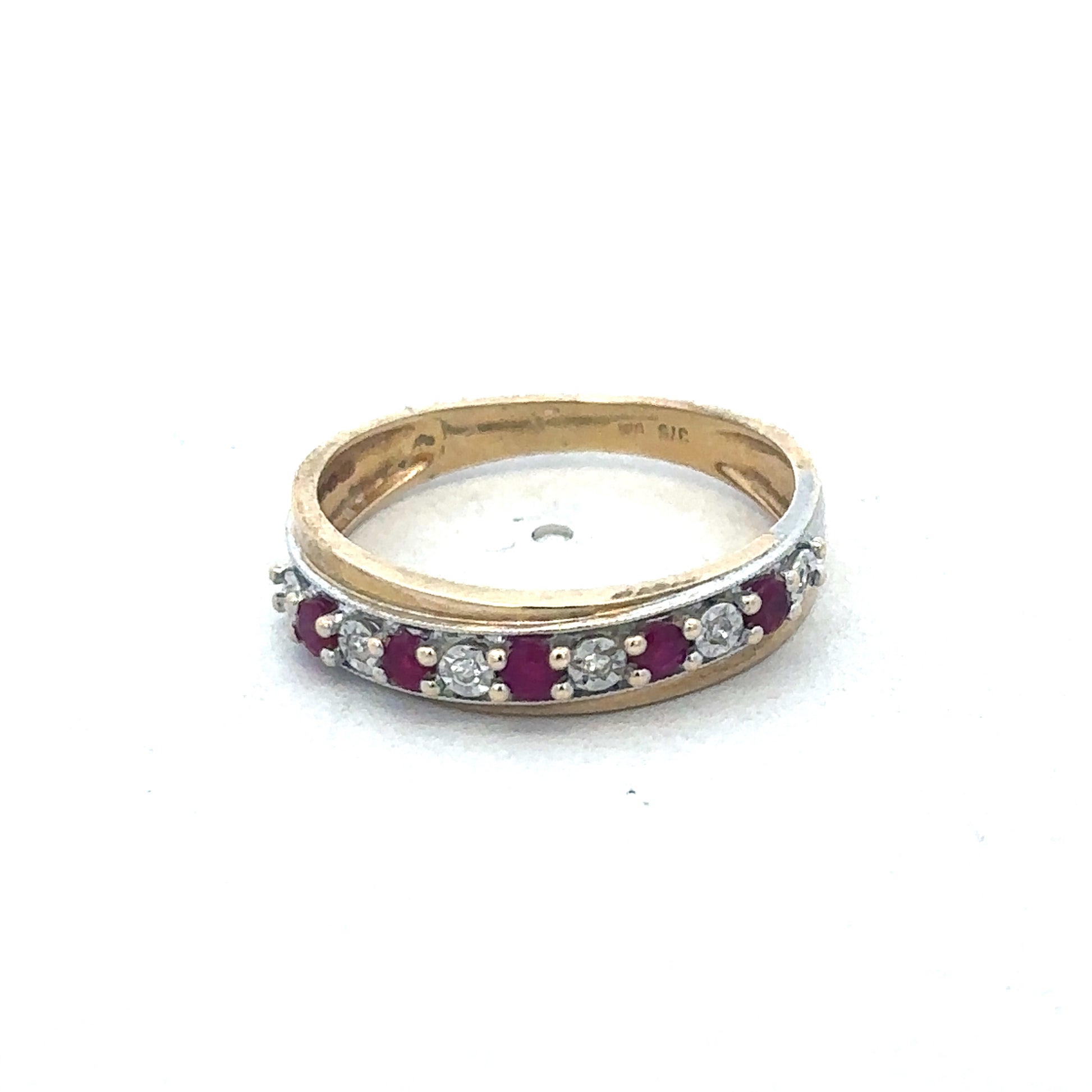 9ct yellow gold ruby and diamond ring by Reeves and Sons, showcasing a vibrant ruby centerpiece surrounded by sparkling diamonds.