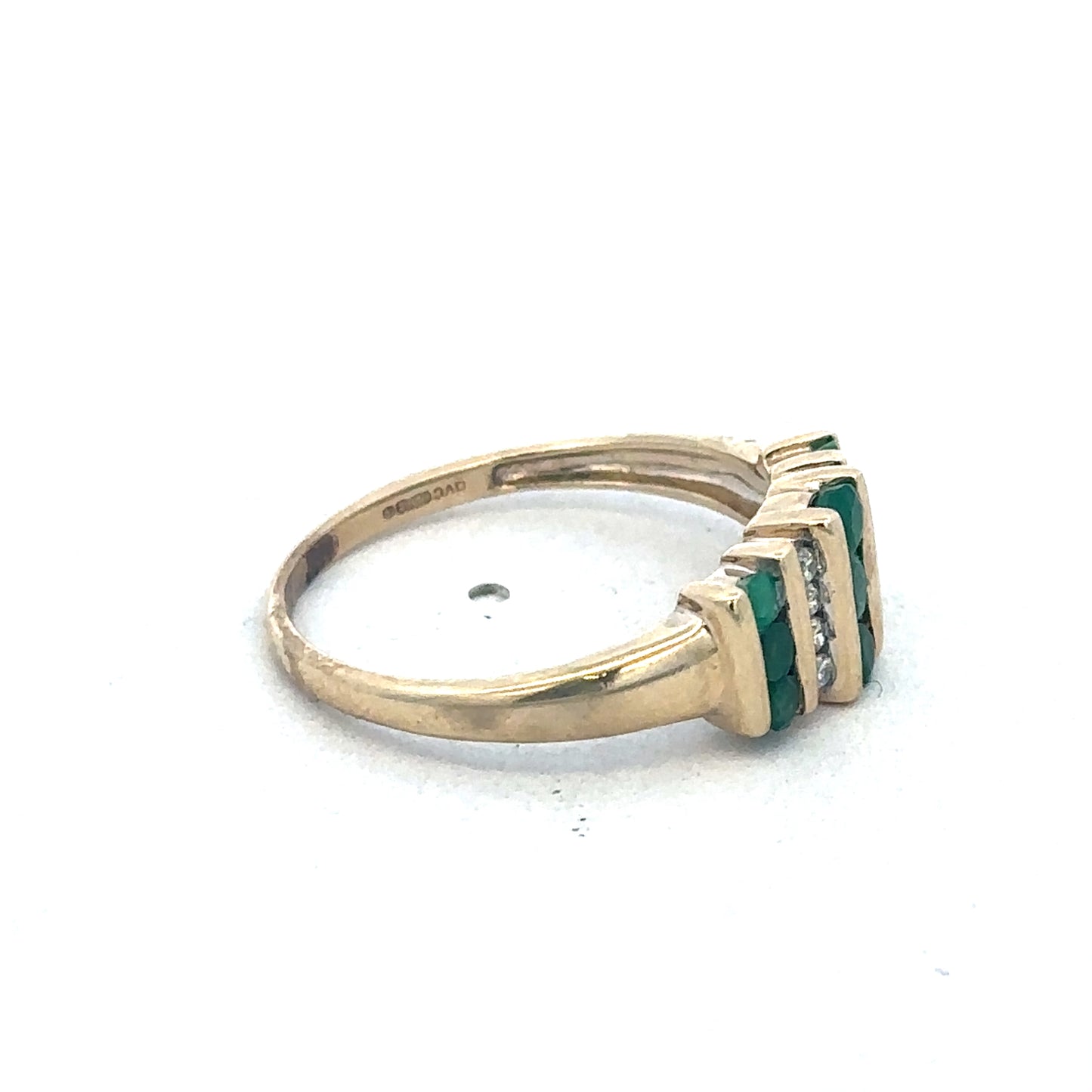 9ct yellow gold emerald and diamond ring by Reeves and Sons with intricate design and sparkling gemstones.