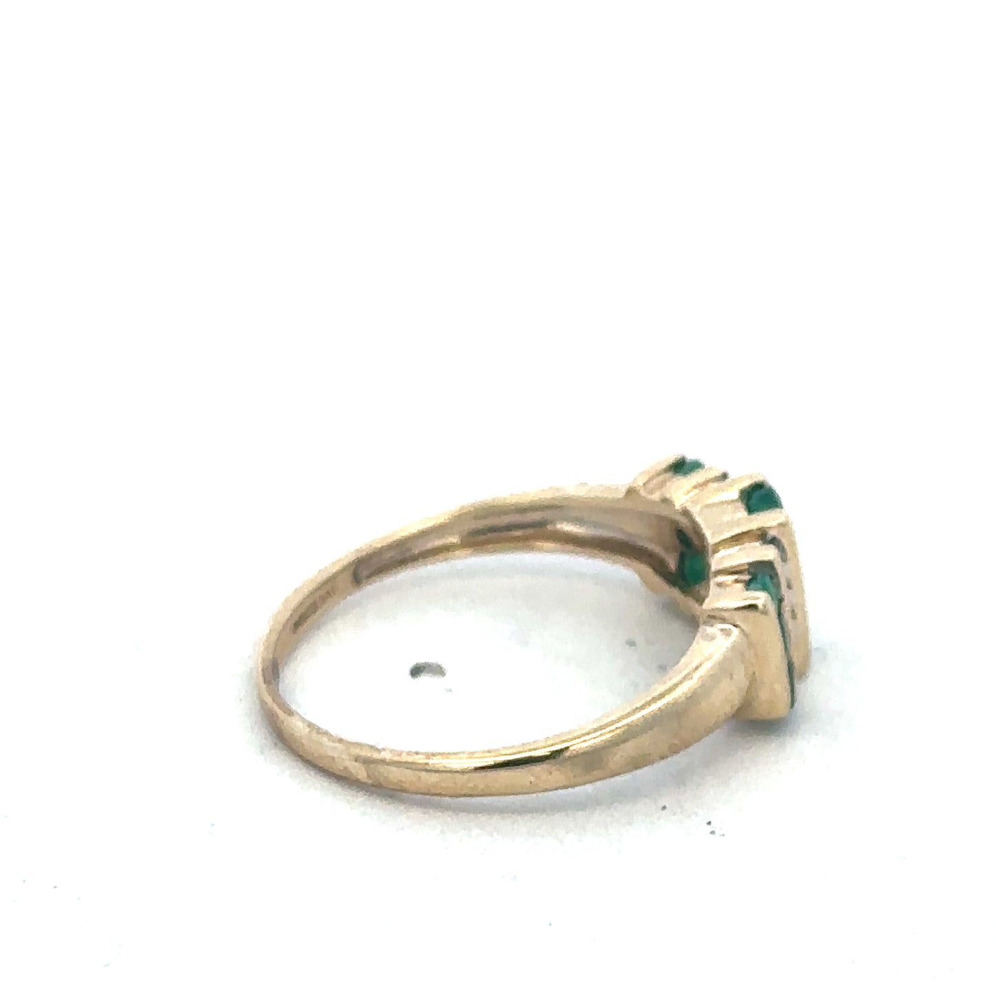9ct yellow gold emerald and diamond ring by Reeves and Sons, featuring a central emerald and sparkling diamonds.