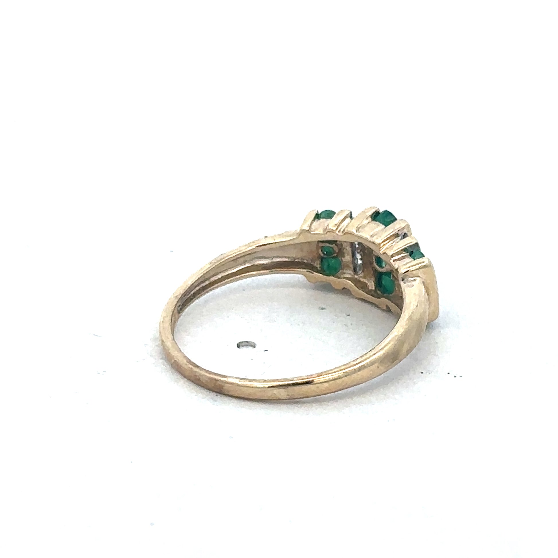 9ct yellow gold emerald and diamond ring by Reeves and Sons with a central emerald gemstone and diamond accents.