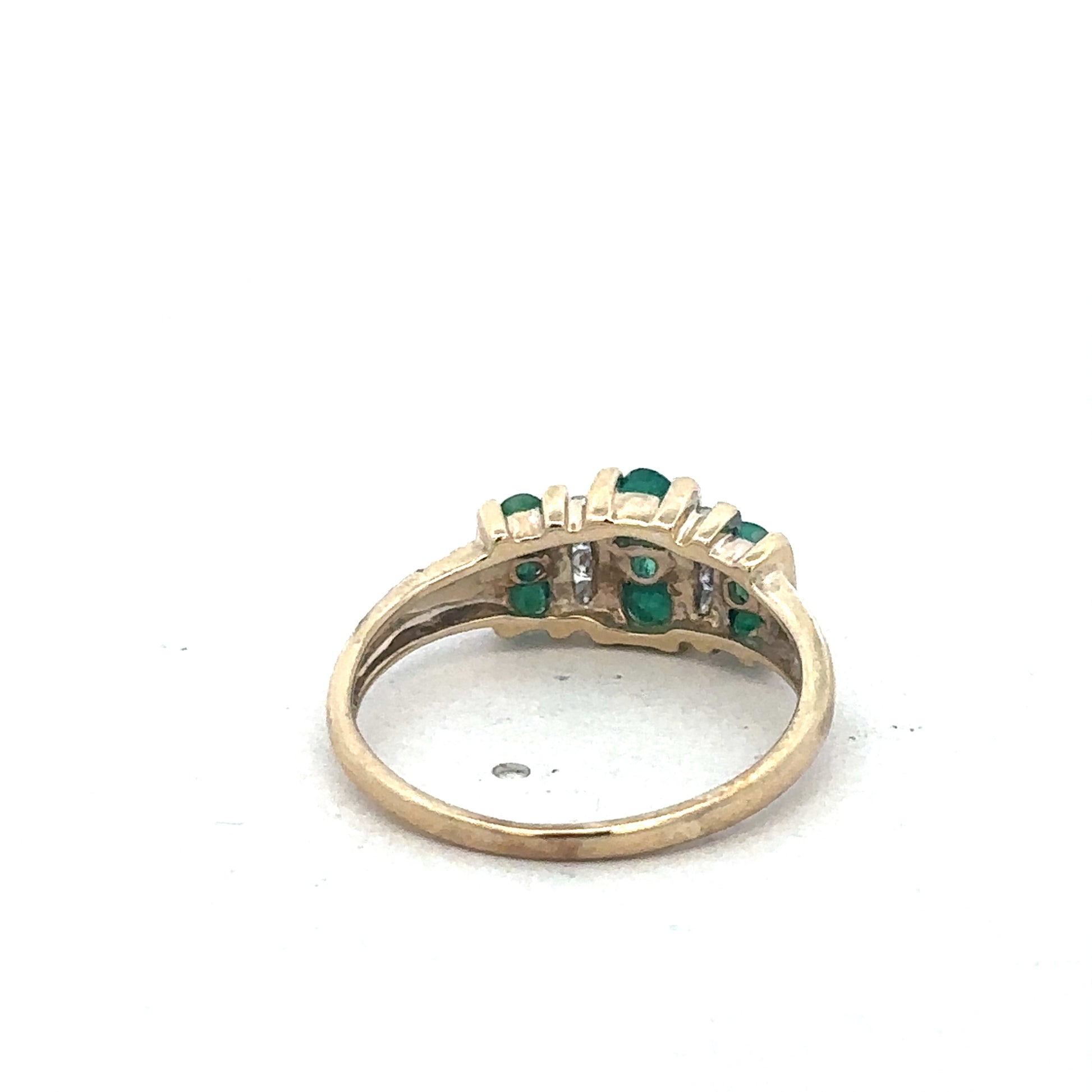 9ct yellow gold emerald and diamond ring by Reeves and Sons, featuring a central emerald gemstone with diamond accents.