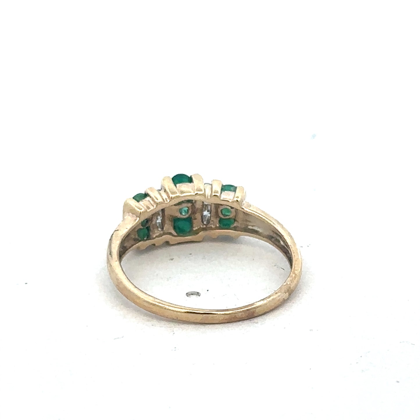 9ct yellow gold emerald and diamond ring by Reeves and Sons, showcasing a vibrant emerald centerpiece with sparkling diamonds.