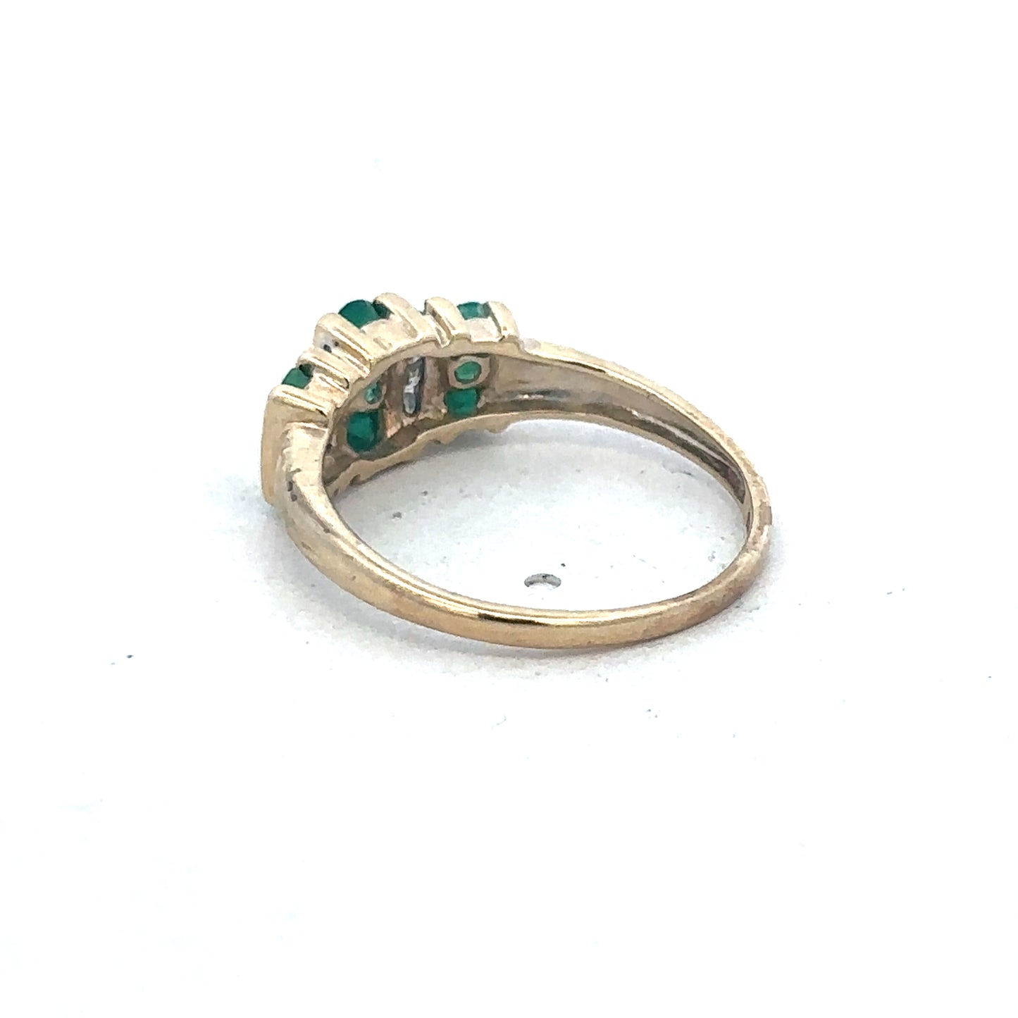 9ct yellow gold emerald and diamond ring by Reeves and Sons, featuring a central emerald gemstone and sparkling diamonds.