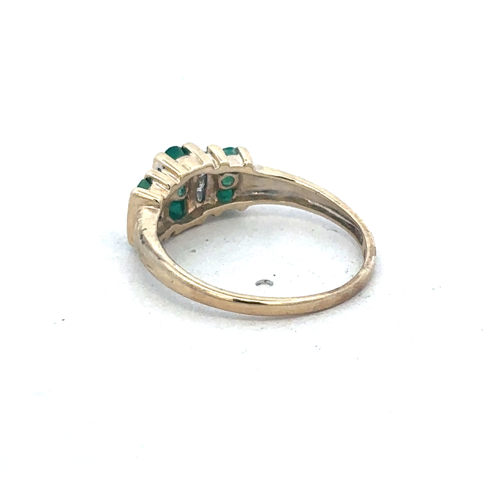 9ct yellow gold emerald and diamond ring by Reeves and Sons, featuring a central emerald gemstone and sparkling diamonds.