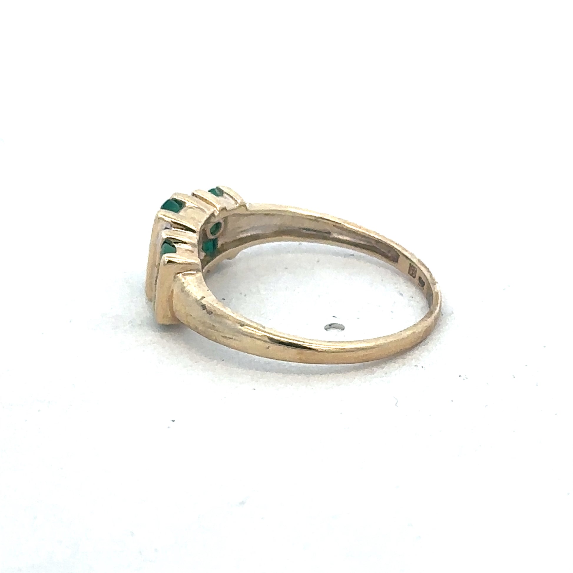 9ct yellow gold emerald and diamond ring by Reeves and Sons, showcasing a central emerald gemstone with diamond accents.
