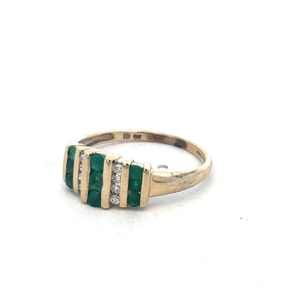 9ct yellow gold emerald and diamond ring by Reeves and Sons, showcasing a vibrant emerald centerpiece with sparkling diamonds.