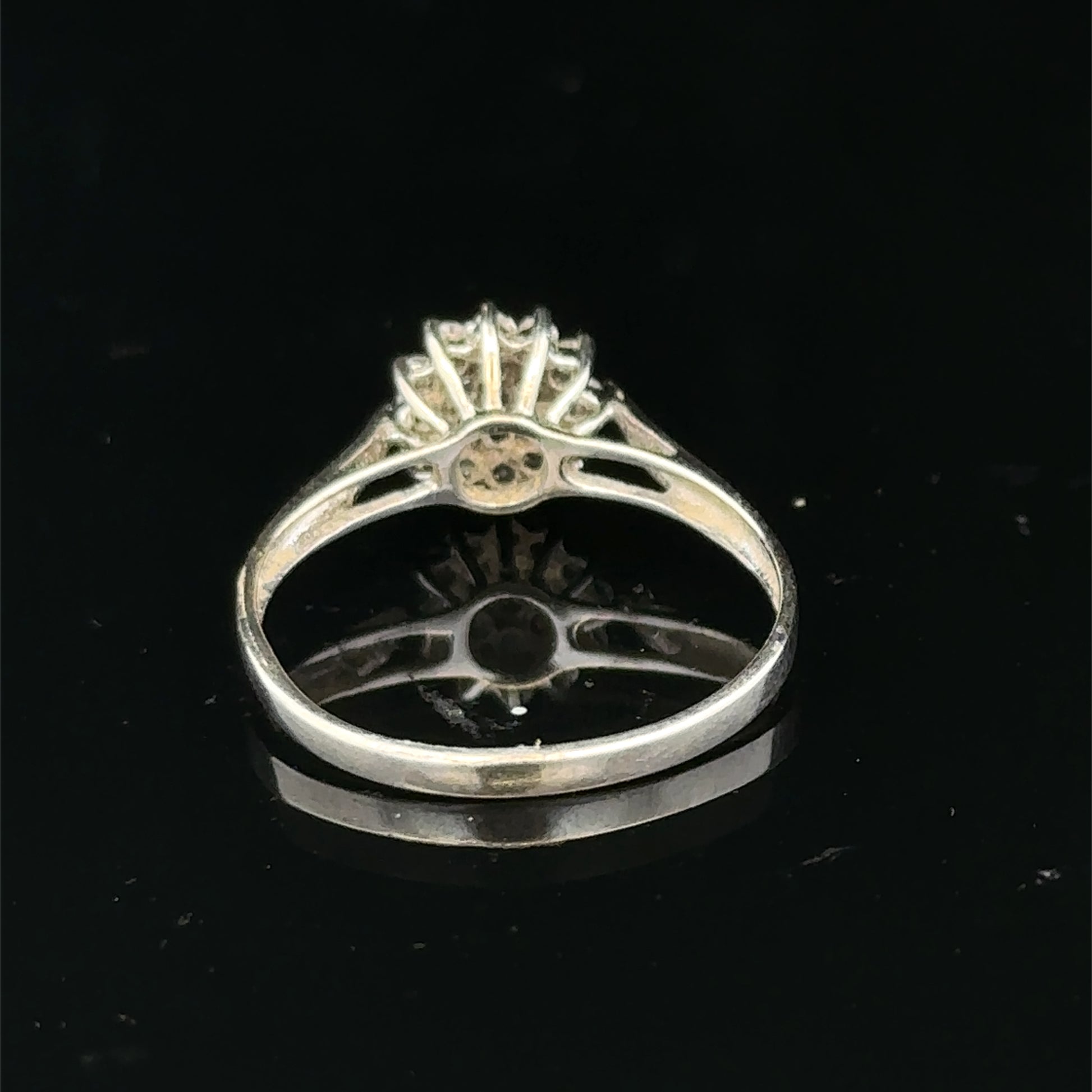 9ct white gold diamond cluster ring by Reeves and Sons, showcasing a sparkling diamond cluster design on a polished band.