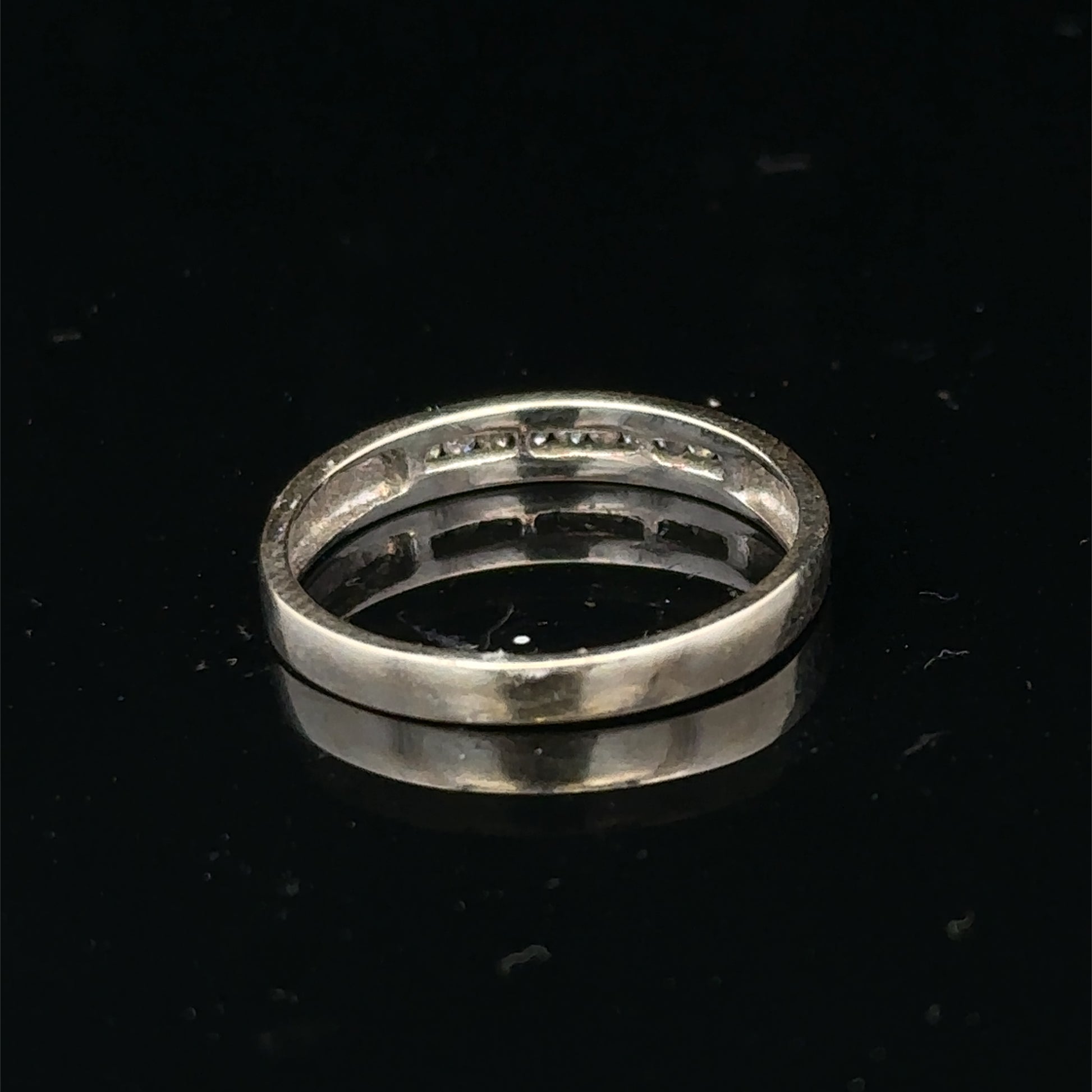 18ct white gold diamond half eternity ring by Reeves and Sons, showcasing sparkling diamonds and elegant band design.