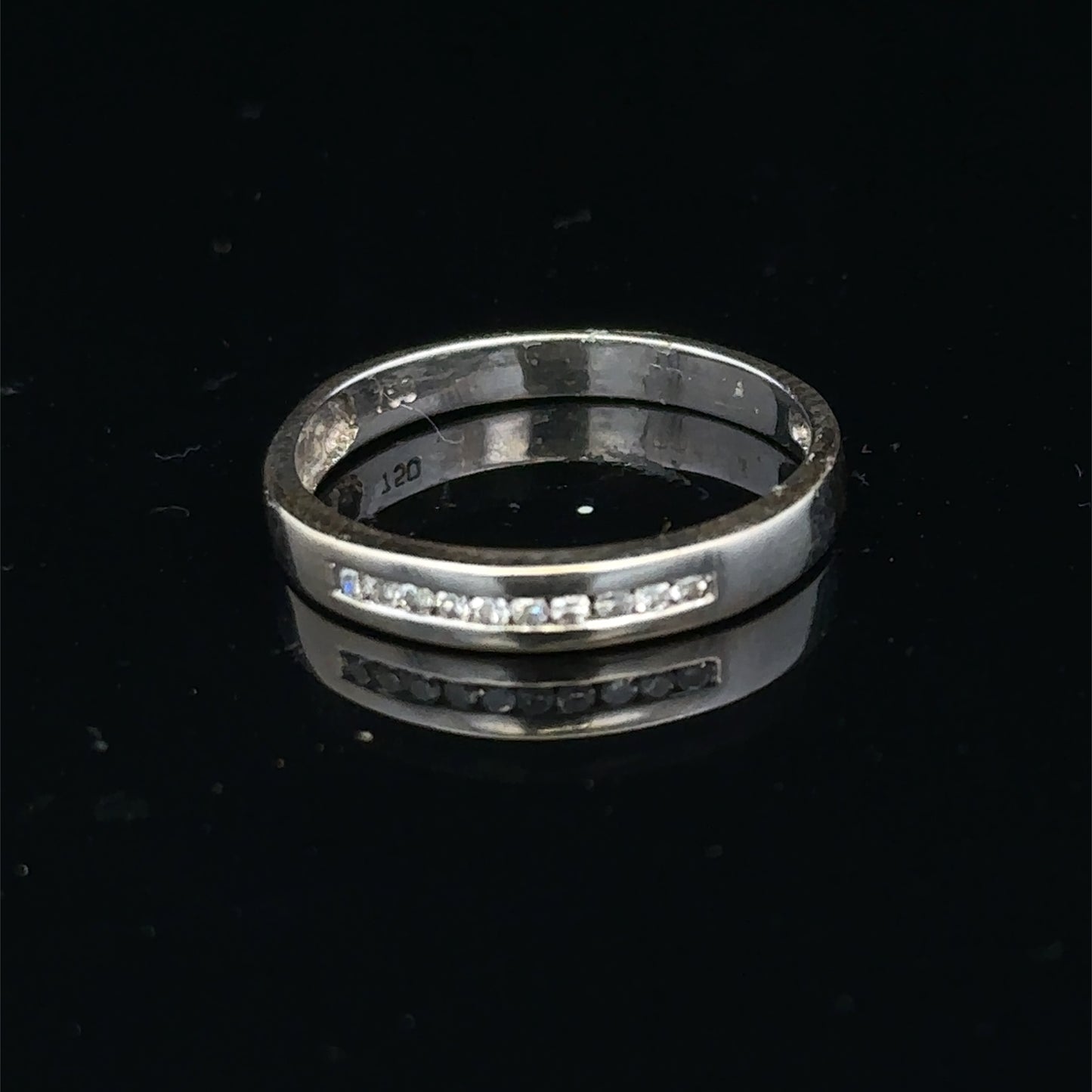 18ct white gold diamond half eternity ring featuring sparkling diamonds set in a sleek band by Reeves and Sons.