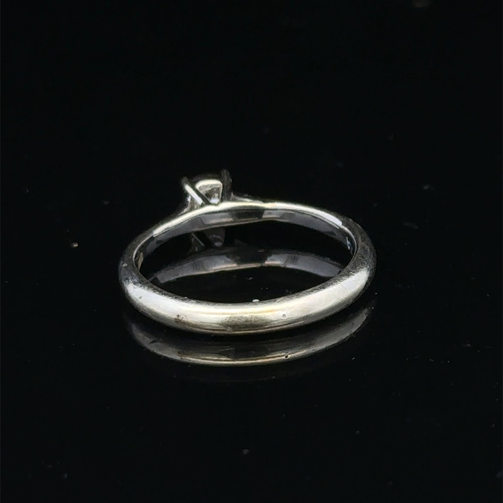 9ct white gold diamond solitaire ring by Reeves and Sons, featuring a sparkling central diamond and elegant design.