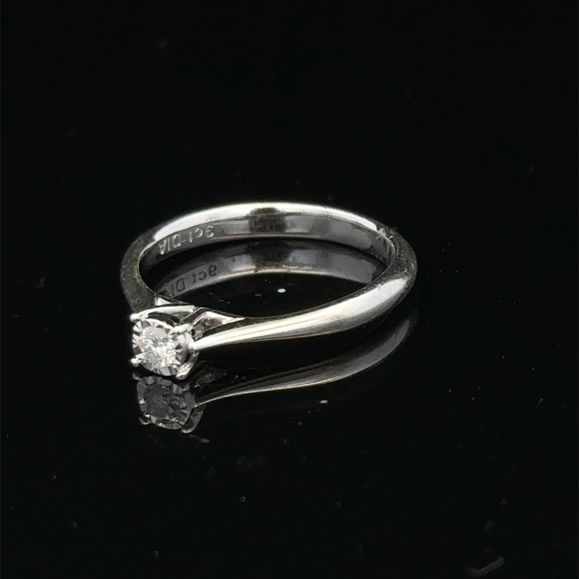 9ct white gold diamond solitaire ring by Reeves and Sons featuring a single sparkling diamond setting.