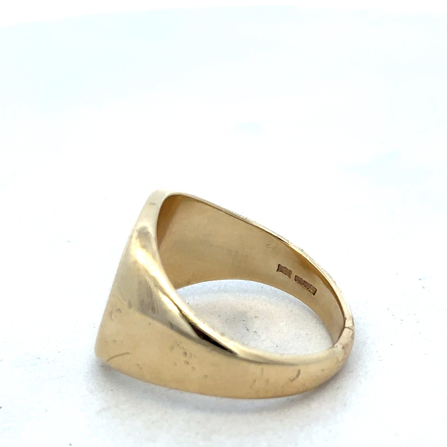 9ct yellow gold signet ring by Reeves and Sons, featuring a polished smooth surface and classic design.