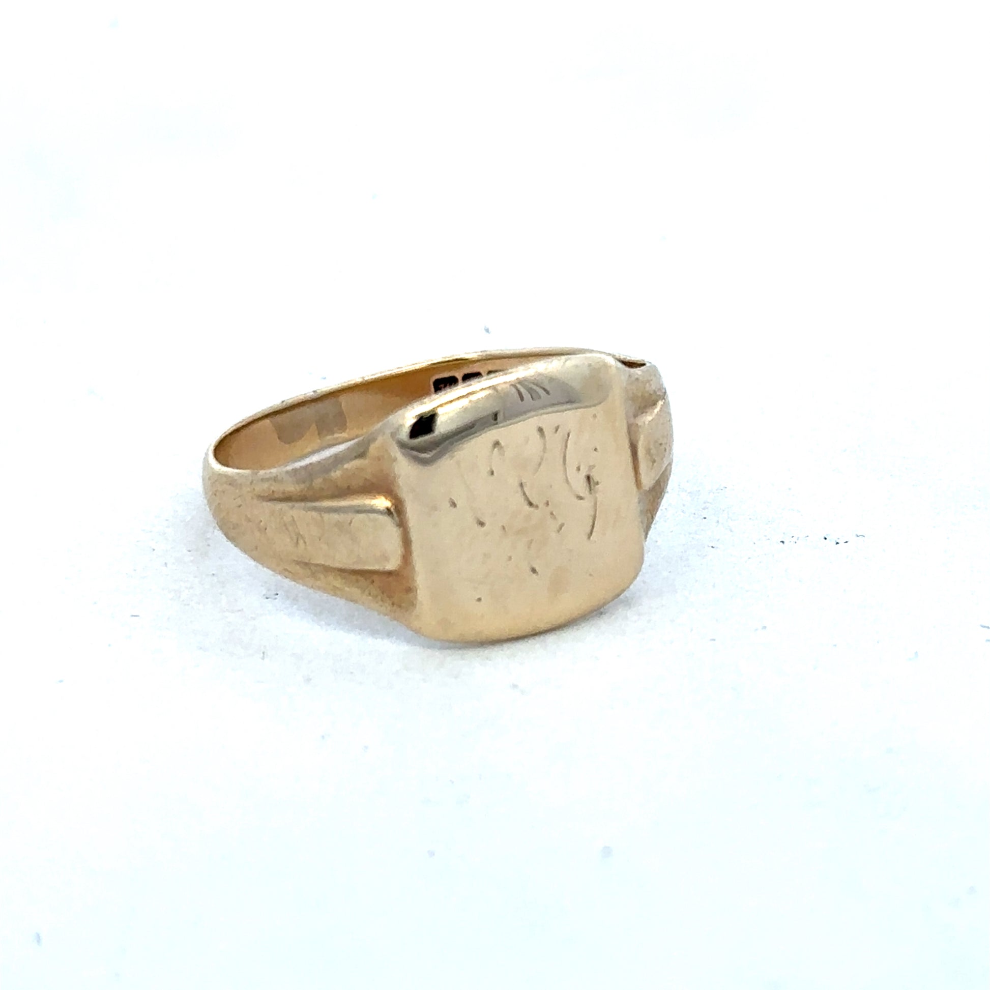 9ct yellow gold ring by Reeves and Sons, showcasing a polished band with subtle design details.