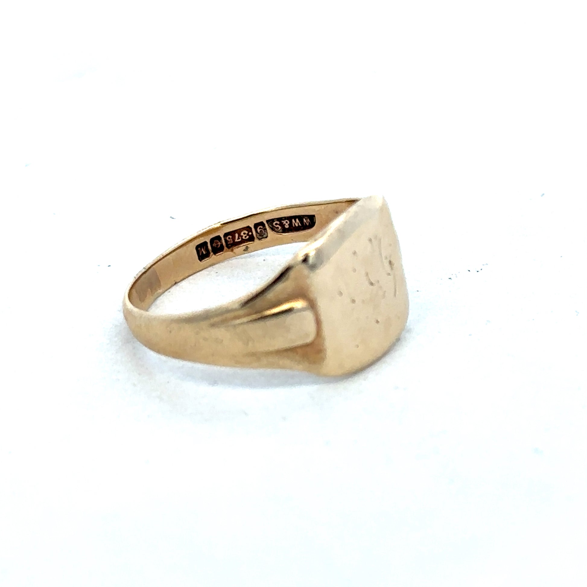 9ct yellow gold ring by Reeves and Sons, featuring a smooth, polished band with a classic design.
