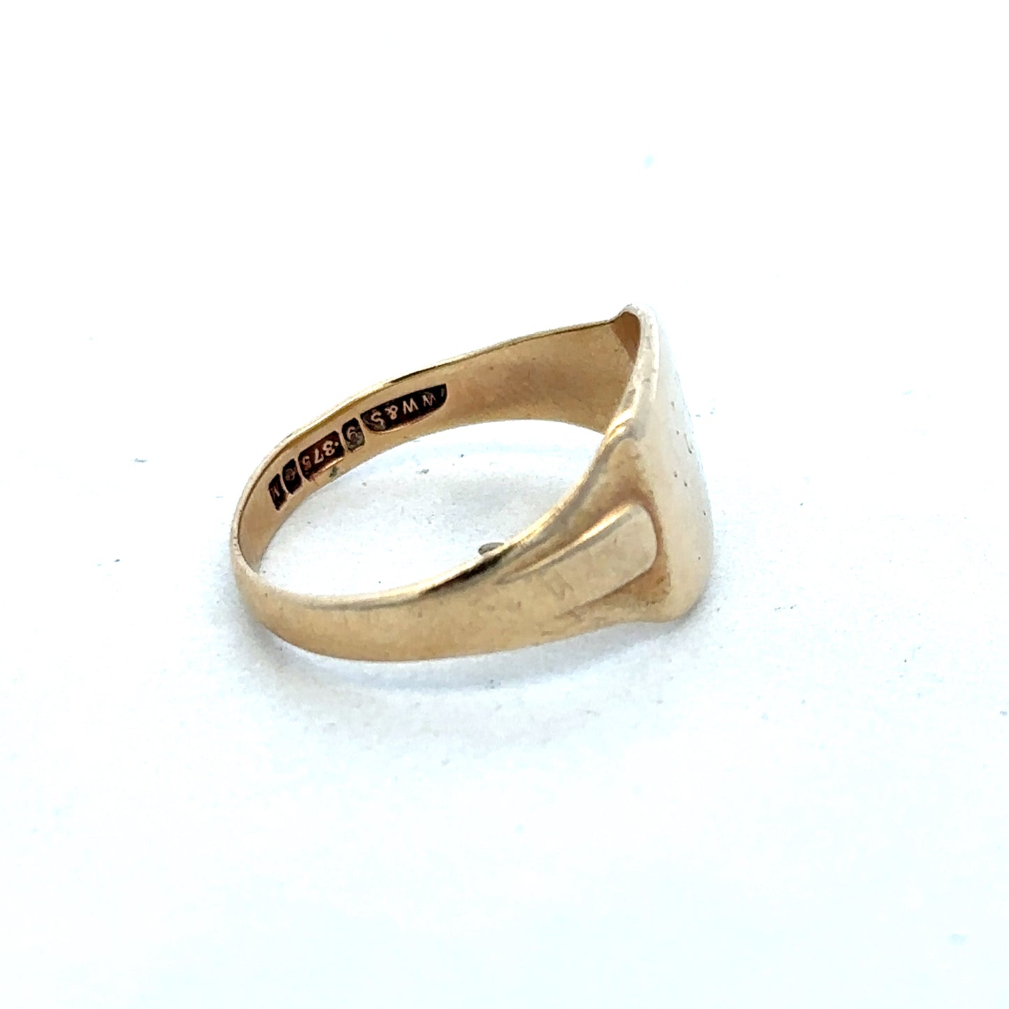 9ct yellow gold ring by Reeves and Sons, showcasing a polished band with a smooth, elegant finish.