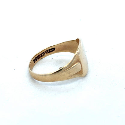 9ct yellow gold ring by Reeves and Sons, showcasing a polished band with a smooth, elegant finish.