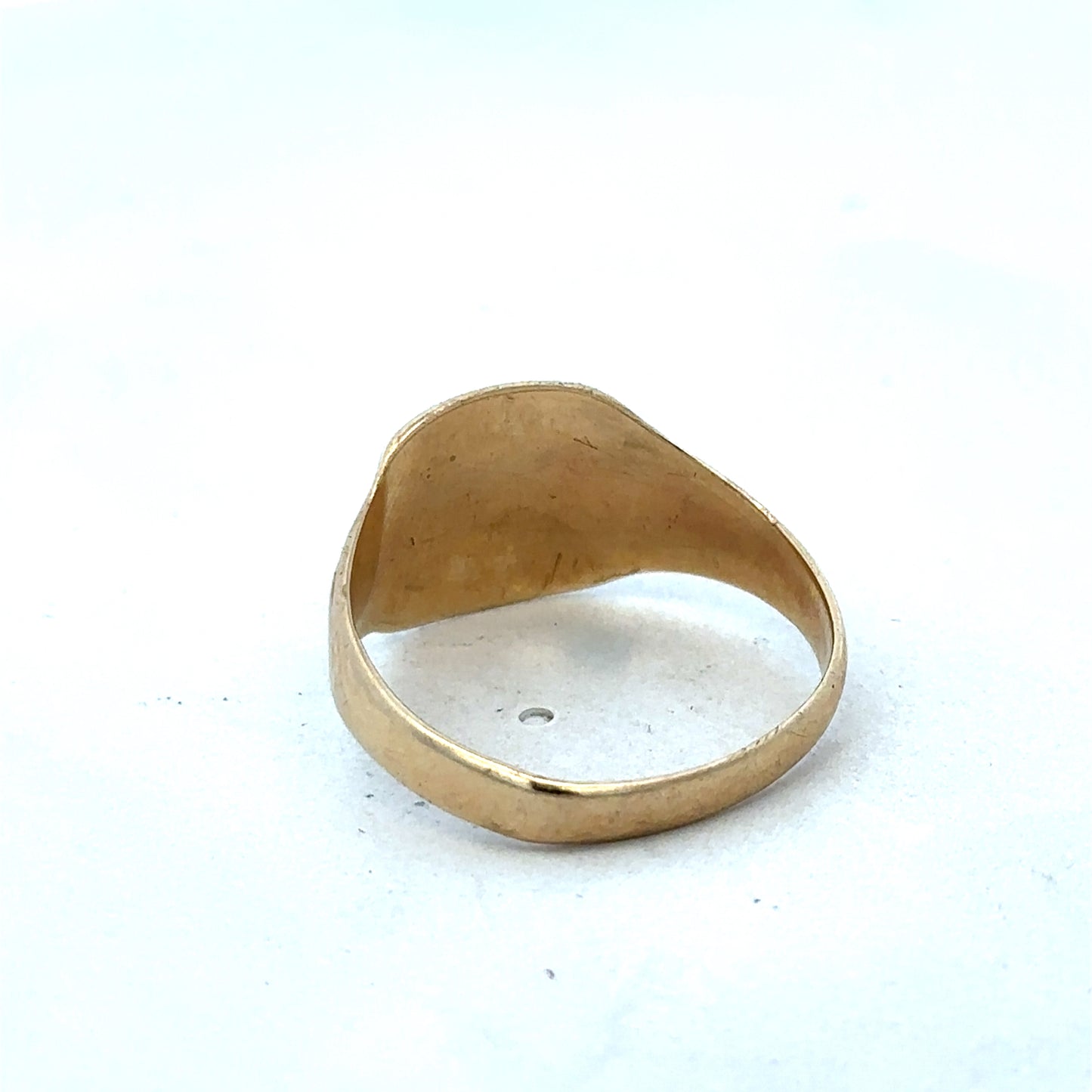 9ct yellow gold ring by Reeves and Sons featuring a classic design and polished finish, displayed on a plain background.