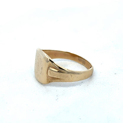 9ct yellow gold ring with simple band design, crafted by Reeves and Sons, shown in close-up on a white background.