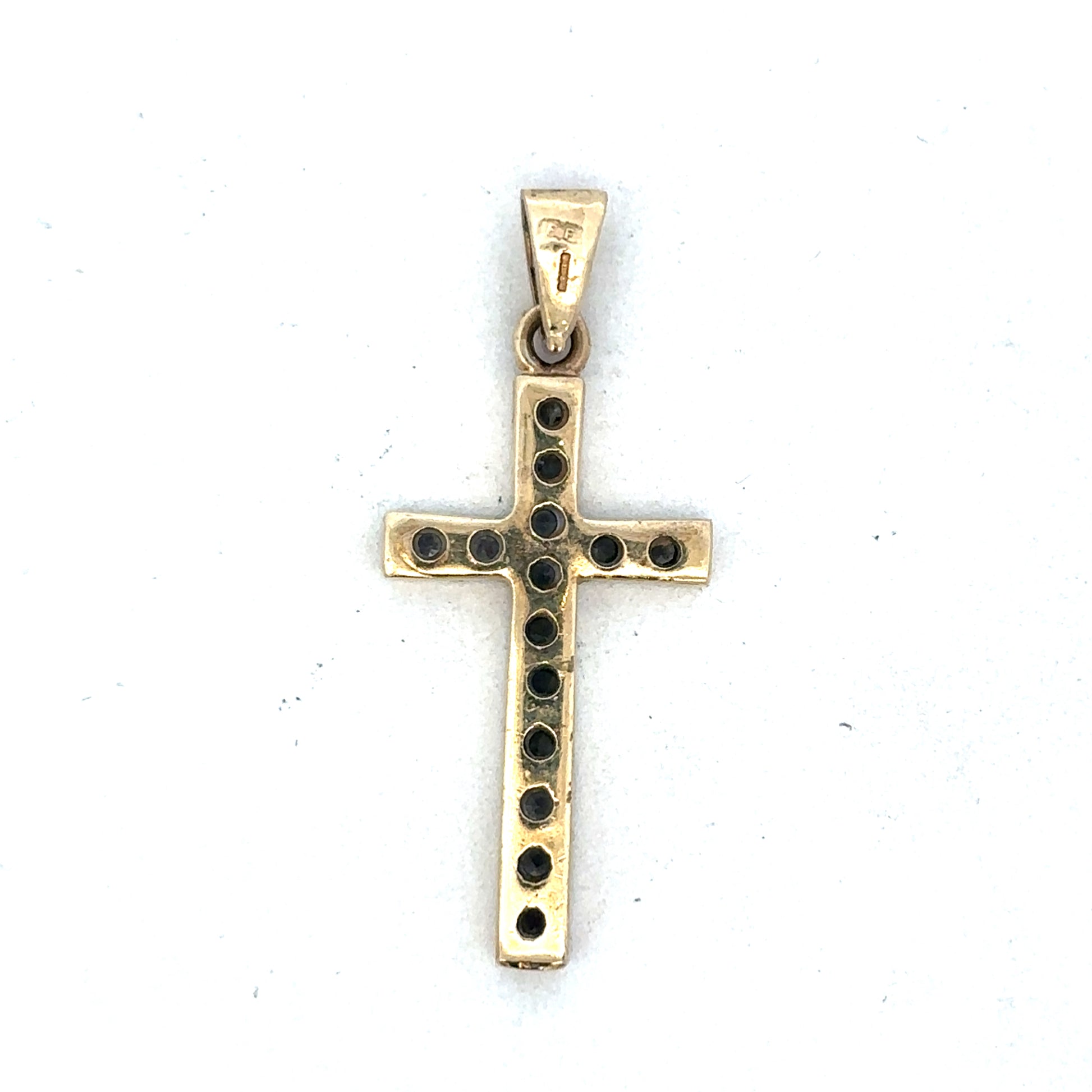 9ct yellow gold cross pendant by Reeves and Sons, showcasing a detailed religious jewelry design.