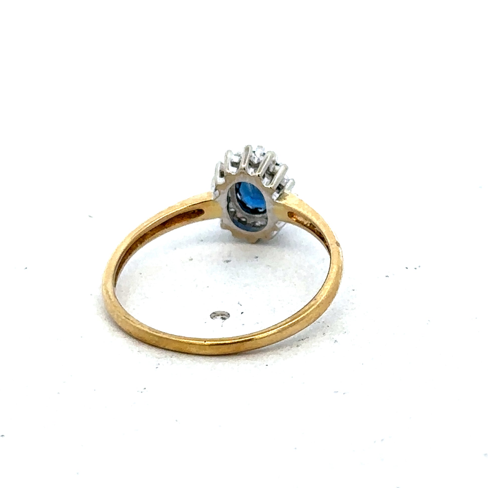 18ct yellow gold sapphire and diamond ring by Reeves and Sons, size L1/2, featuring a central sapphire with diamond accents.