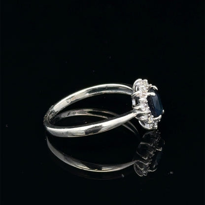 9ct white gold sapphire and diamond ring in size L, featuring a central sapphire with diamond accents, by Reeves and Sons.