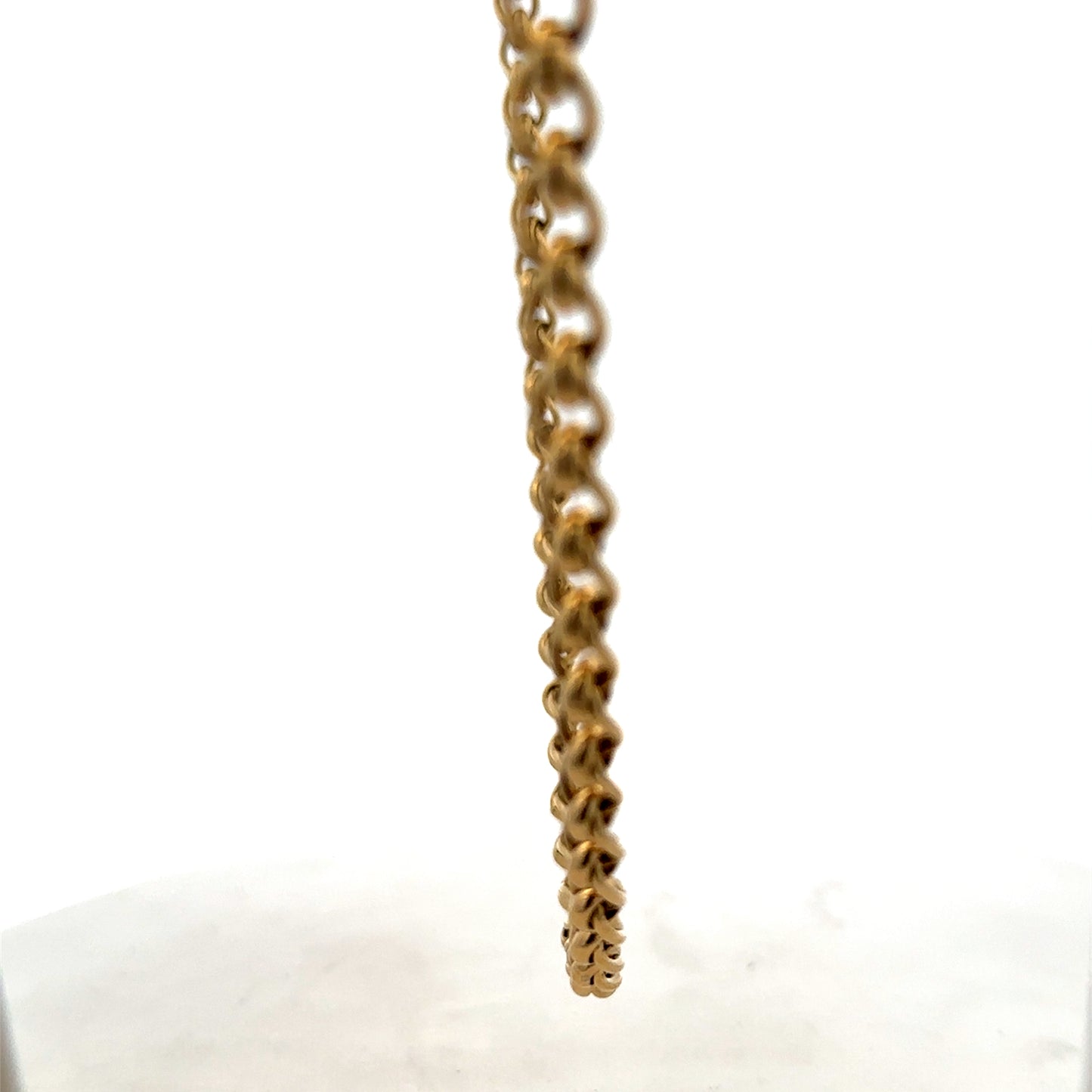 Reeves and Sons 9ct yellow gold rollerball chain, 33.9g, close-up of the shiny, textured gold chain showing its links.