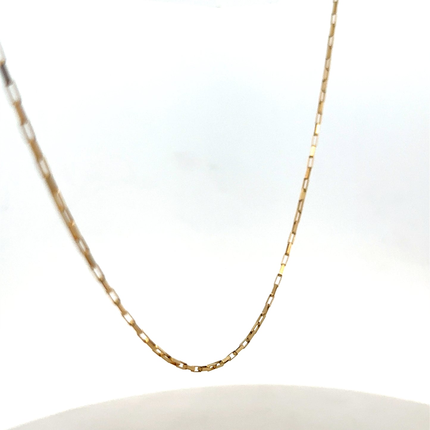 9ct yellow gold chain from Reeves and Sons, showcasing a delicate, polished jewelry chain with a secure clasp.