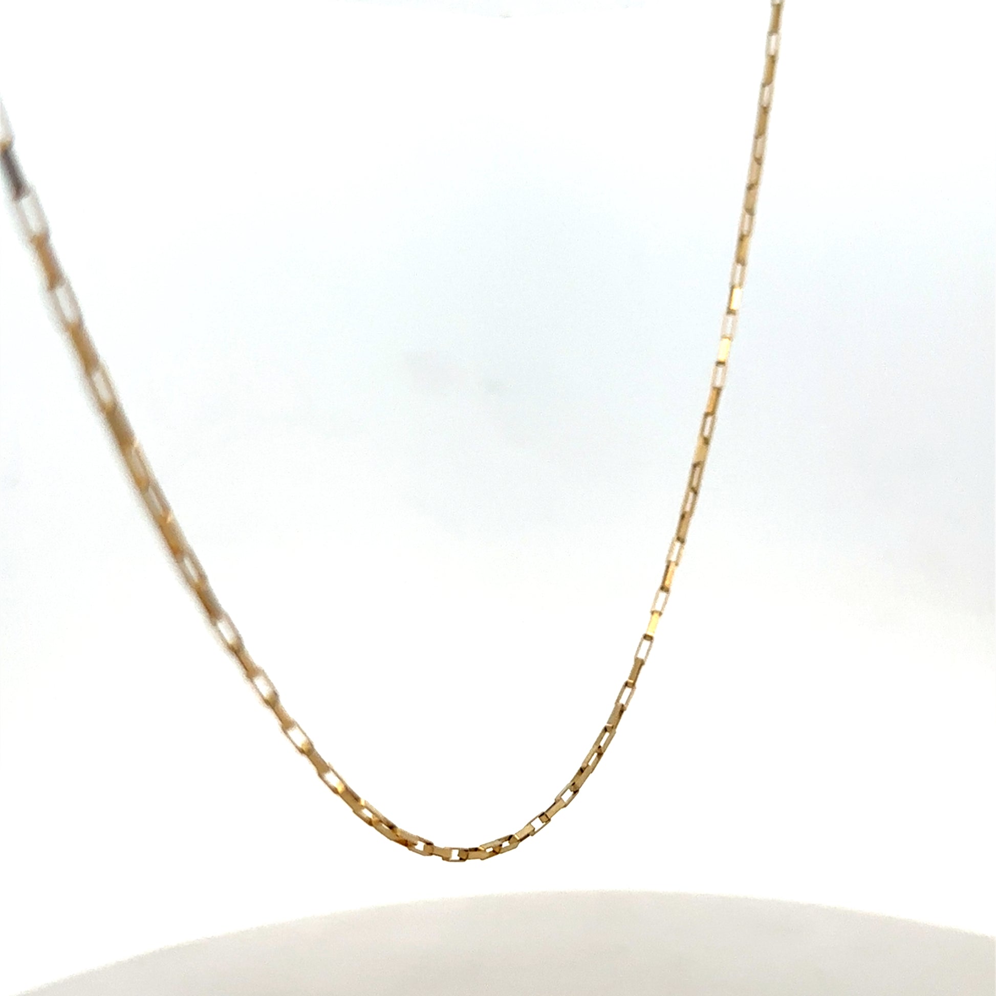 9ct yellow gold chain from Reeves and Sons, showcasing a delicate, polished jewelry chain with a secure clasp.