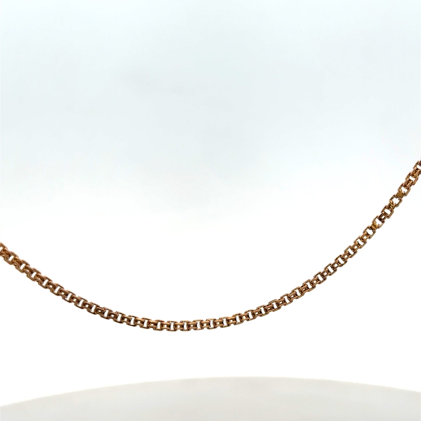Reeves and Sons 9ct yellow gold chain, 6.5g, with a delicate link design, shown laid flat against a neutral background.
