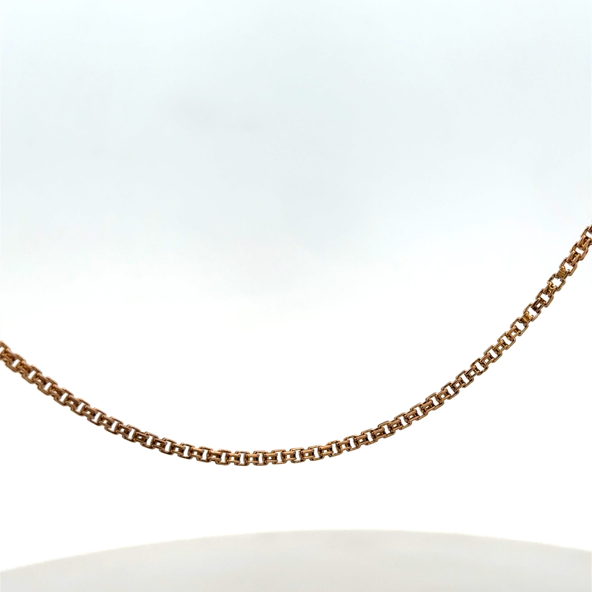 Reeves and Sons 9ct yellow gold chain, 6.5g, with a delicate link design, shown laid flat against a neutral background.