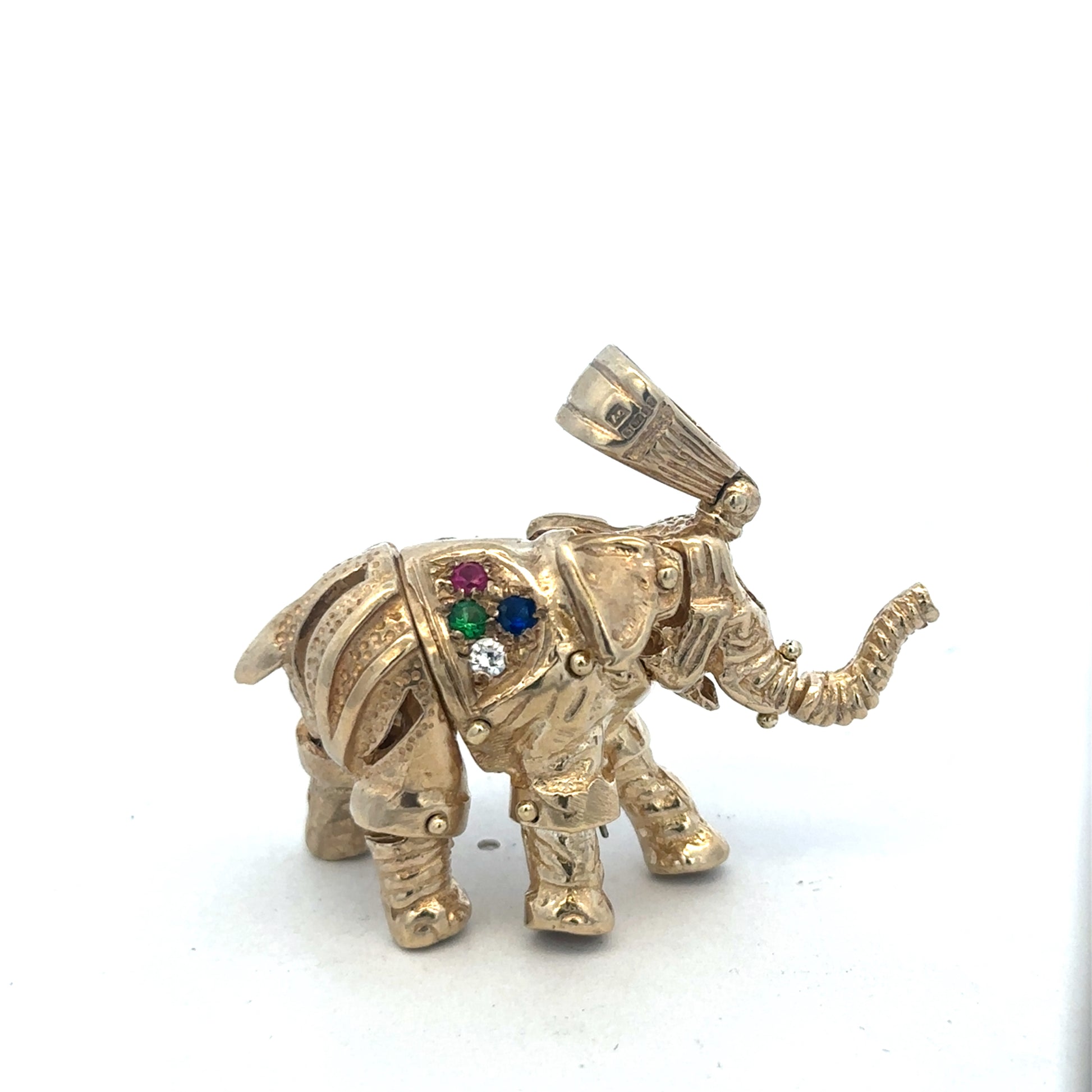 9ct yellow gold elephant pendant with detailed design, weighs 25.3g, by Reeves and Sons, displayed on a plain background.