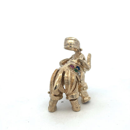 9ct yellow gold elephant pendant with intricate detailing, weighs 25.3g, from Reeves and Sons, displayed on a plain background.
