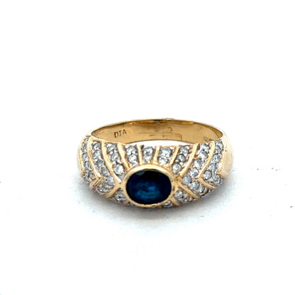 18ct yellow gold diamond ring in size P with sparkling diamonds, by Reeves and Sons, shown on a neutral background.