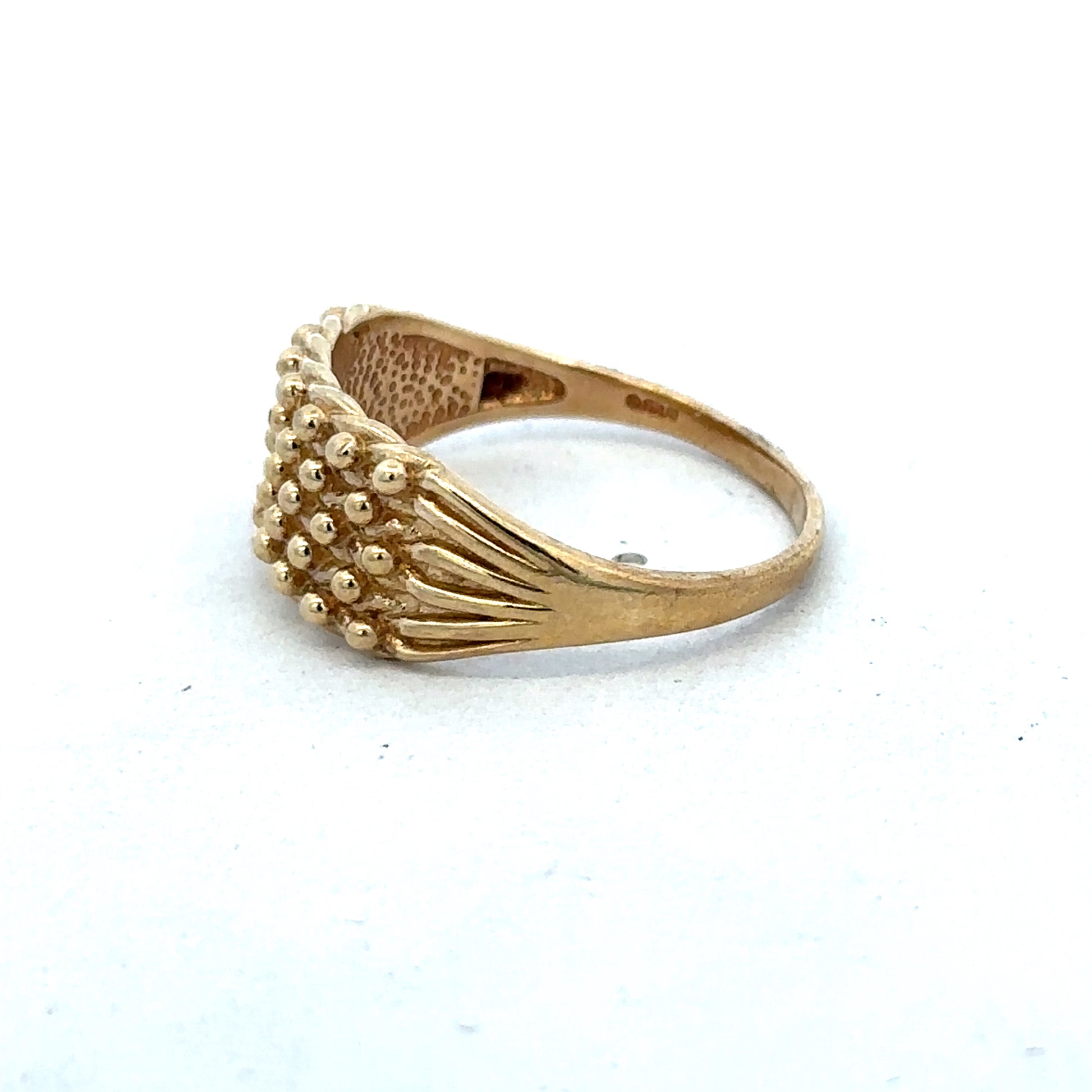 9ct yellow gold keeper ring in size W with a polished finish, designed by Reeves and Sons, shown on a plain background.