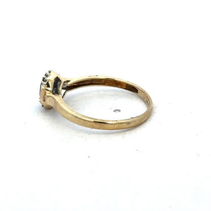 9ct yellow gold emerald and diamond ring with intricate band design, size R, by Reeves and Sons.