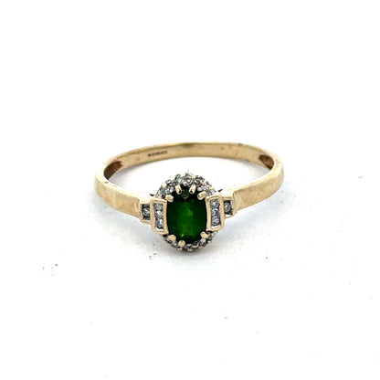 9ct yellow gold emerald and diamond ring by Reeves and Sons, size R, featuring a central emerald and sparkling diamonds.